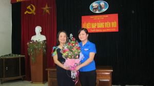 Đồng chí Phạm Thị Thu Huyền - Đảng ủy viên, Bí thư Đoàn trường trường Cao đẳng Tuyên Quang tặng hoa quần chúng Nguyễn Thị Loan.